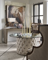 Cascade Dining Table shown with:Latte finish with Aged Medici finish trimDiamond Tufted upholstery60" Diameter glass top