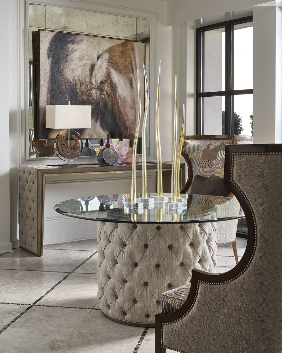 Cascade Dining Table shown with:Latte finish with Aged Medici finish trimDiamond Tufted upholstery60" Diameter glass top