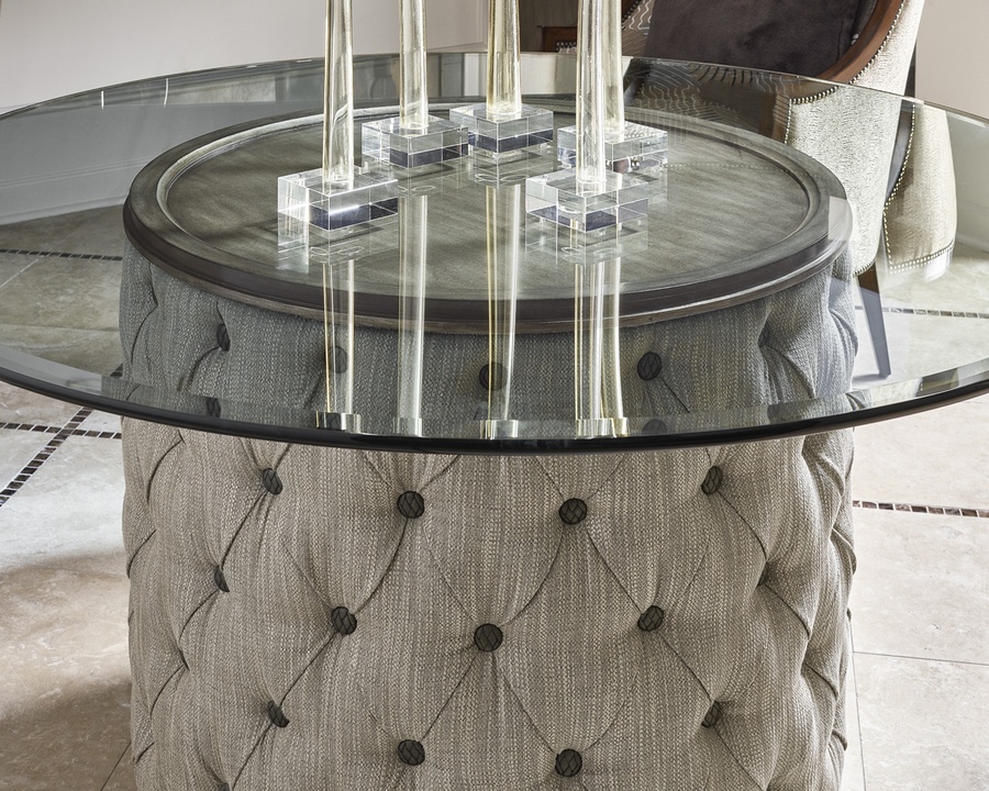 Cascade Dining Table shown with:Latte finish with Aged Medici finish trimDiamond Tufted upholstery60" Diameter glass top