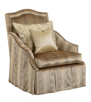 Marcella&nbsp;Chair shown with:Boxed seat cushionBox pleated waterfall front skirt with dressmakersides and back and button detailAntique Heritage nailhead frame trim